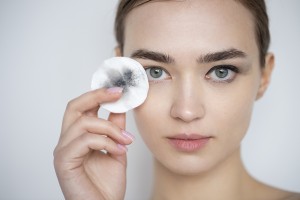 portrait-of-beautiful-woman-with-clear-skin-using-make-up-remover-pad-for-her-eye-make-up